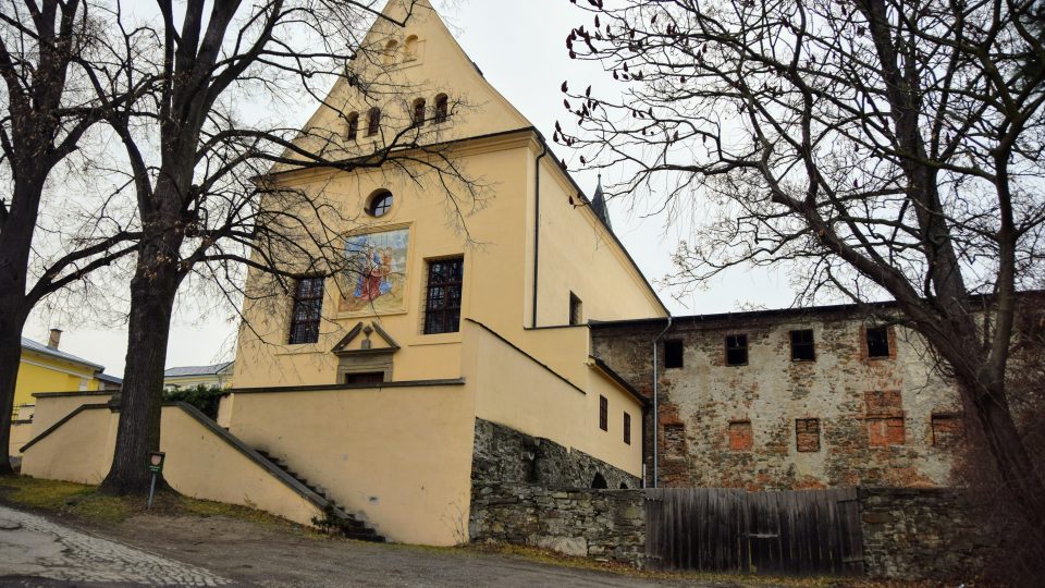 Vlevo opravený kostel, napravo zchátralý klášter